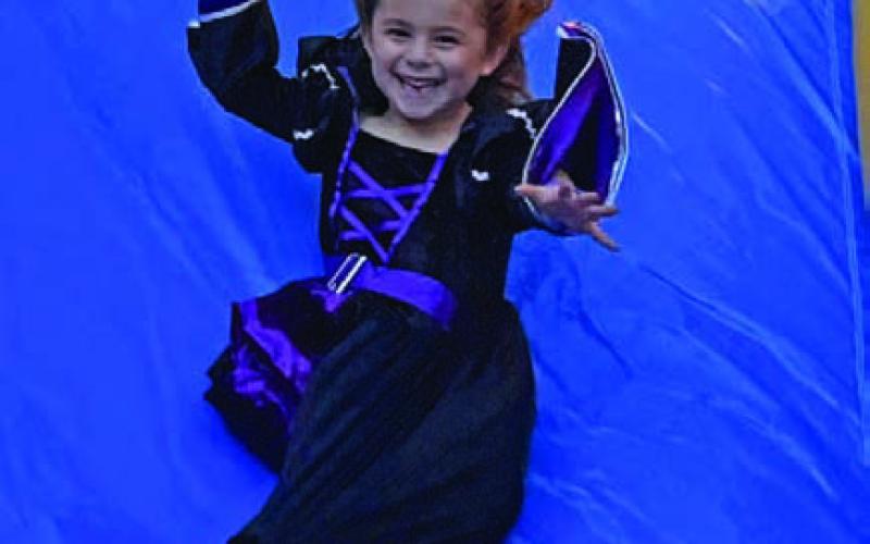The evening included a bounce house, petting zoo, games, hot dogs, popcorn, vendors, carriage rides, face painting and a haunted house, among other activities.