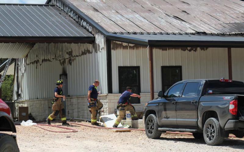Crews remained on the scene of a house fire Wednesday on County Road 3064 after the flames were extinguished. The homeowner was in the house at the time of the fire and escaped without injuries. Joycesarah McCabe | Dispatch Record
