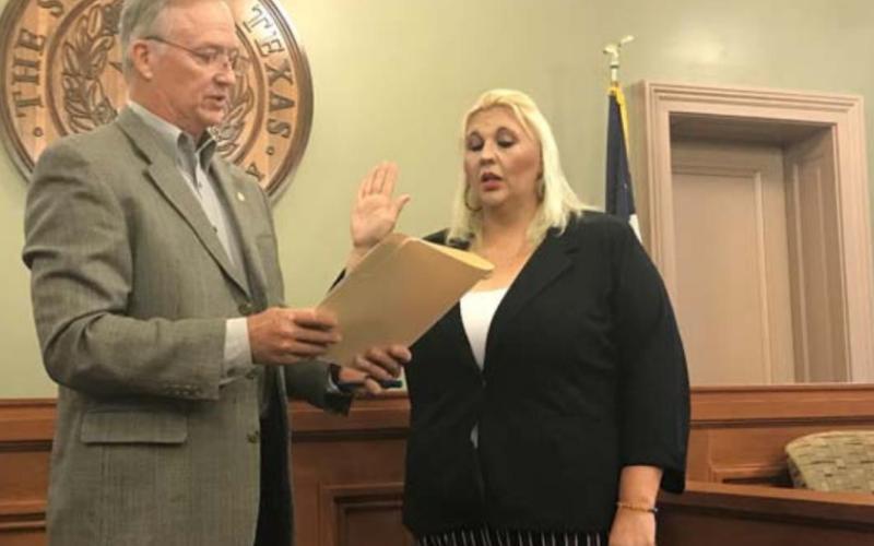County Judge Randy Hoyer swears in Misty Wakeman as Precinct 1 justice of the peace on Friday morning. MONIQUE BRAND | DISPATCH RECORD