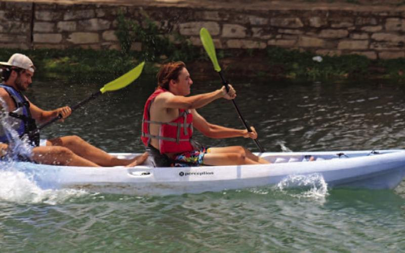 Tate Rainwater and Aden Rascoe paddle like experts in the 2023 Spring Ho Adult Tandem Kayak Race, where they took home the win. AJOYCESARAH MCCABE | DISPATCH RECORD