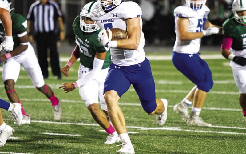 Jett Walker breaks through the Taylor defense on one of his four touchdowns last Friday. HUNTER KING | DISPATCH RECORD