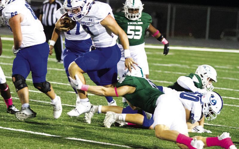 Reed Jerome leaps through the tackle of a Taylor defender. HUNTER KING | DISPATCH RECORD