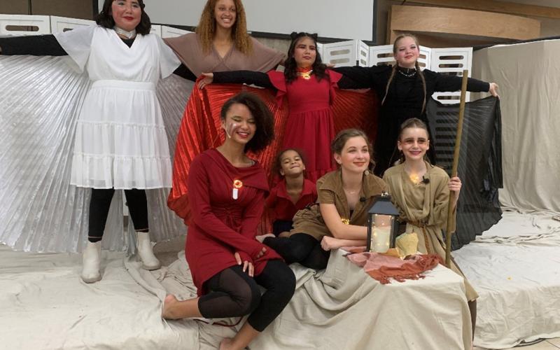 Providence Christian Academy theater instructor Juliana Dwamena, standing second from left, poses with cast members of “The Fire Within.” courtesy photo