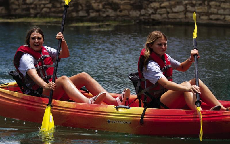 Sagen Plouff and Pacey Underwood paddle down the creek during the youth tandem race last Saturday. HUNTER KING | DISPATCH RECORD