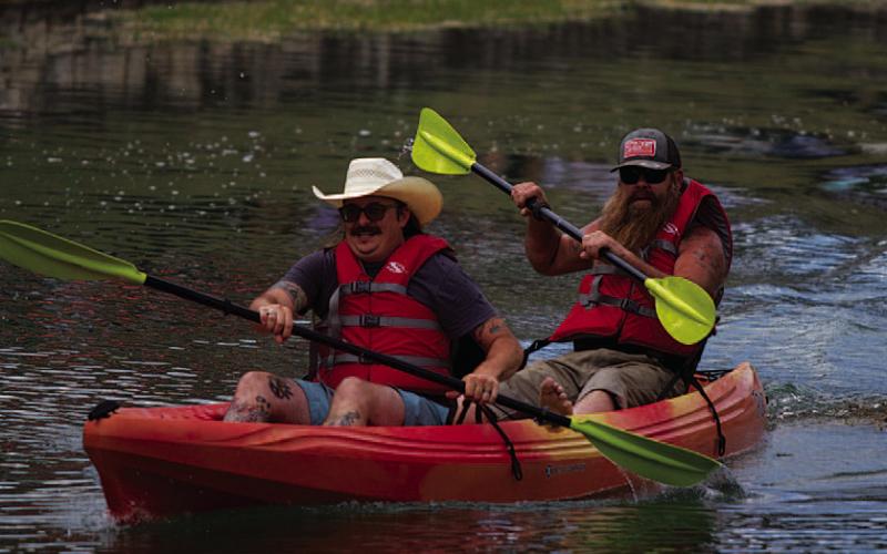 Zac Morris and Blair Redd speed to the finish line during the annual kayak races. HUNTER KING | DISPATCH RECORD