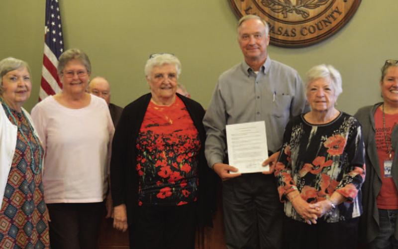 American Legion Auxiliary Unit 277 volunteers pose for a photo alongside County Judge Randy Hoyer after the court adopted a proclamation recognizing May 24 as National Poppy Day. Lampasas County residents are encouraged to wear a memorial poppy to honor America’s fallen heroes. ERICK MITCHELL | DISPATCH DISPATCH