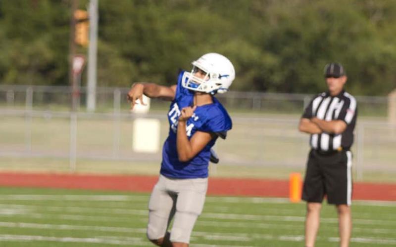 Badger quarterback Dylan Sanchez launches a ball deep into the air looking for a receiver downfield during the first scrimmage against Marble Falls. HUNTER KING | DISPATCH RECORD