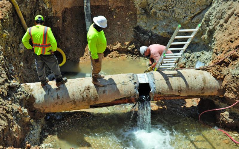 Workers empty the Kempner Water Supply Corp.’s main transmission line to Lampasas in July after a major leak occurred. ERICK MITCHELL | DISPATCH RECORD