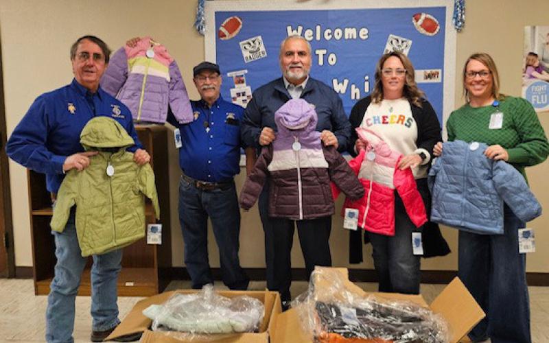 Delivering coats to Kline Whitis Elementary were Knights of Columbus members, from left, Rey Medrano, Bacillio Zamanegio and Jess Ramos; shown with school counselor Mandy Warren and Assistant Principal Tracie Chapa, who assisted with the donation. jim tracy | courtesy photo