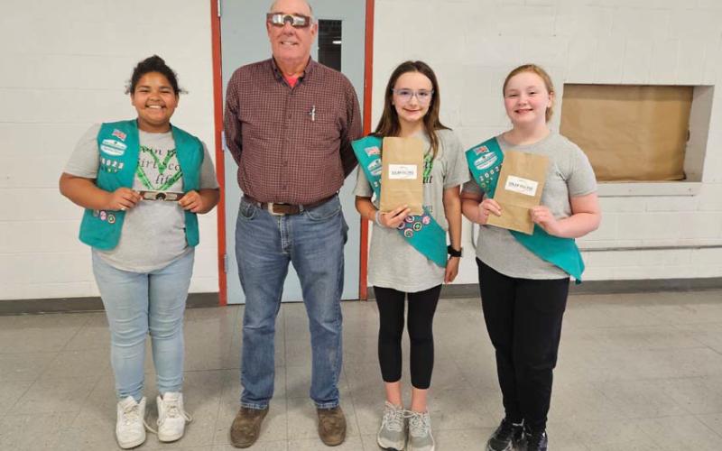 Scouts Vera-Rose Johnson, at left, Rylie Wood and Anna Figurski are pictured with Pillar Bluff Vineyards owner Gil Bledsoe, who donated eclipse glasses for all the students in the Lampasas Independent School District. courtesy photo