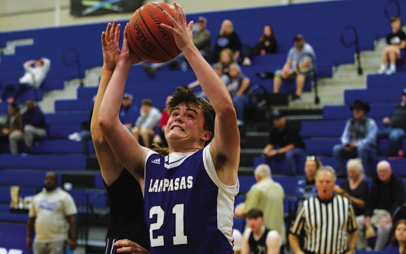 Sam Williams goes up against contact for a layup against Robinson on Tuesday. HUNTER KING | DISPATCH RECORD