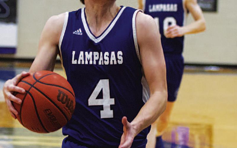 HUNTER KING | DISPATCH RECORD Calum Mitchell looks up at the rim before going for a dunk during scrimmages.