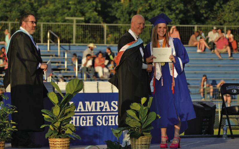 LHS Salutatorian Kenzie Roberts accepts her diploma from outgoing Principal Joey McQueen. ERICK MITCHELL | DISPATCH RECORD
