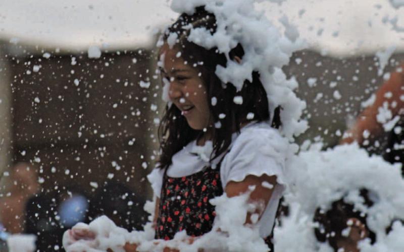 Lilianna Trevino is mesmerized by the falling “snow” she and her family enjoyed last Saturday at the annual Christmas on the Creek event. DAVID LOWE | DISPATCH RECORD