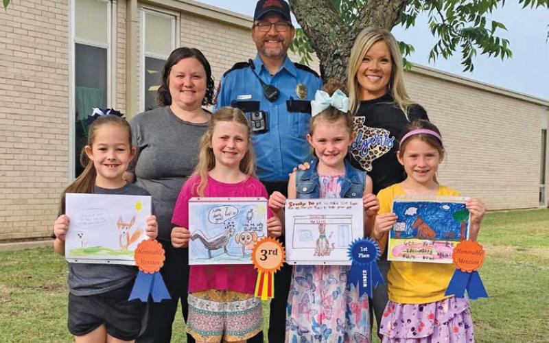 Front row, left to right, are Kylee Kruppa, Ava Latham, Kylee Davis and Evie de Klerk. These students were recognized by the Texas Department of Health and Human Services for their artwork in the department’s Rabies Awareness and Prevention Poster Contest. Back row are Kasey Schwartzer, supervisor of the local animal shelter; animal control officer Joseph Schwartzer; and Kline Whitis Principal Leanne Bobo. erick mitchell | dispatch record