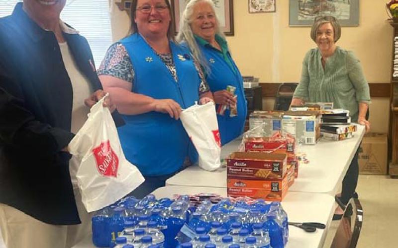 Salvation Army volunteers work with Walmart employees to prepare snack bags for first responders who were on call during the total solar eclipse. courtesy photo