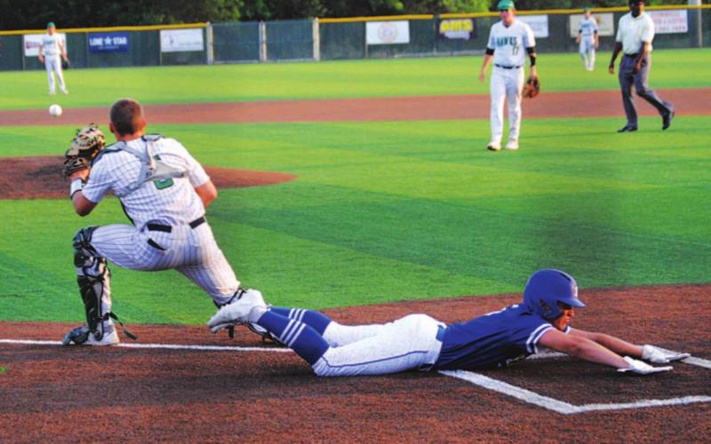 Dax Brookreson slides into home as part of the Badgers’ five-run inning to start the second game of the doubleheader last Saturday. HUNTER KING | DISPATCH RECORD