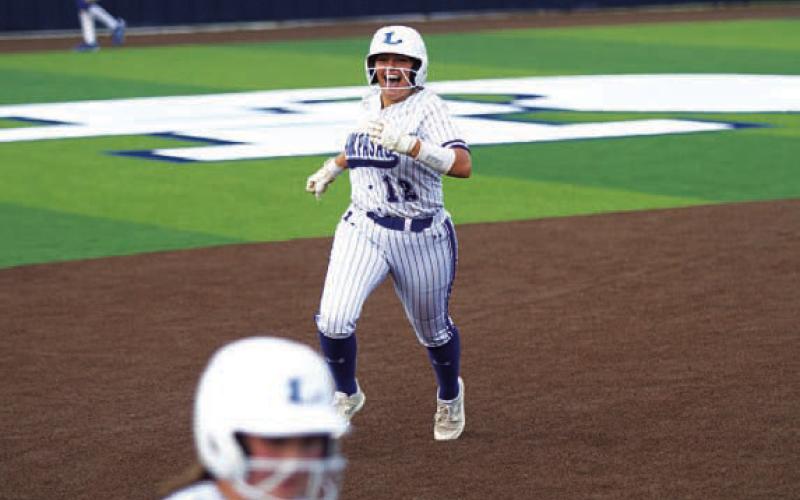 HUNTER KING | DISPATCH RECORD Julia Ybarra smiles as she rounds the bases.