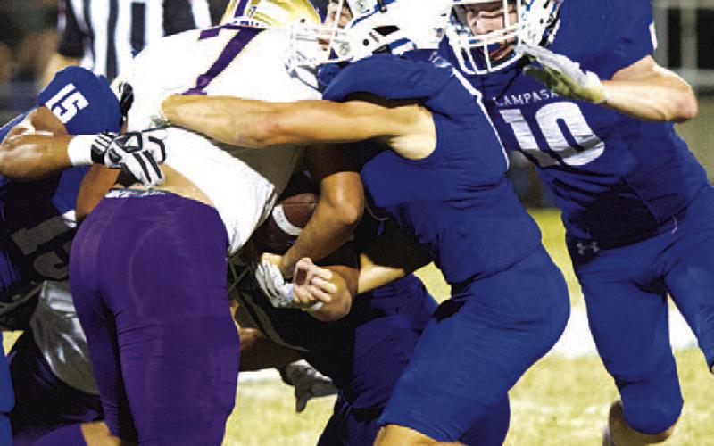Parker Weinheimer joins his teammates on a tackle during last week’s win over Marble Falls. HUNTER KING | DISPATCH RECORD
