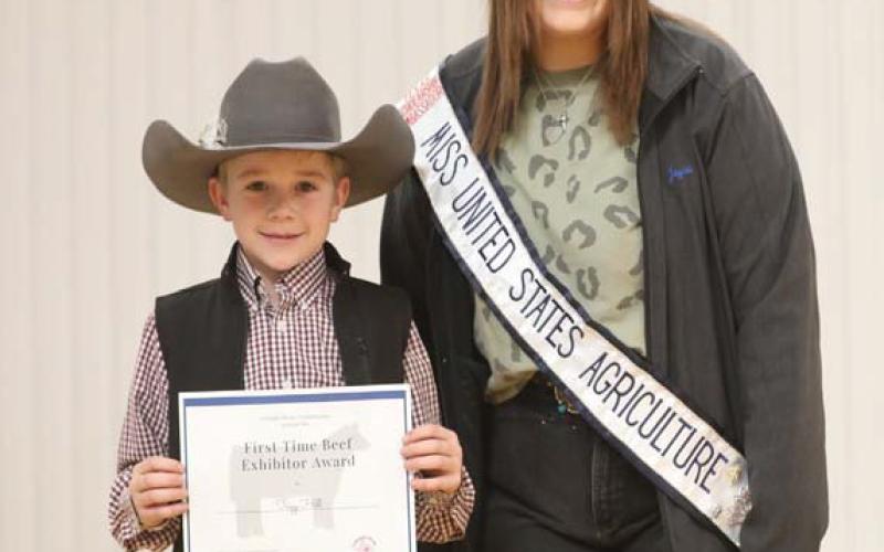 Trigg Hill is following in the footsteps of his older brothers in showing cattle. The Colorado River Cattlewomen and Miss United States Agriculture presented him a certificate as a beef exhibitor. COURTESY PHOTO