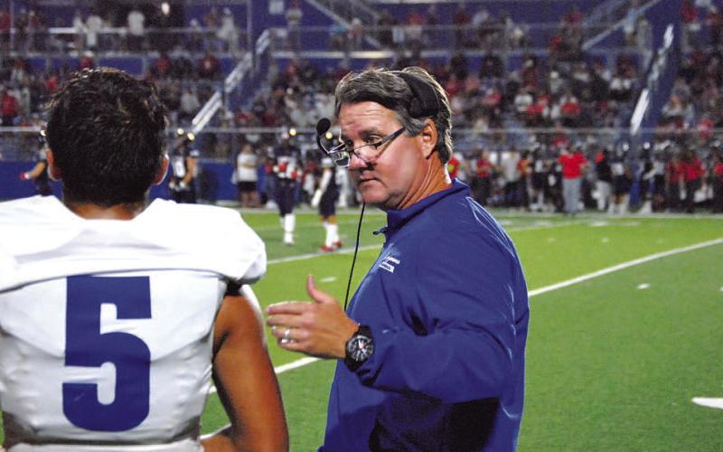 HUNTER KING | DISPATCH RECORD Head coach Troy Rogers coaches his quarterback David Flores in the second half of the East View game last Friday.