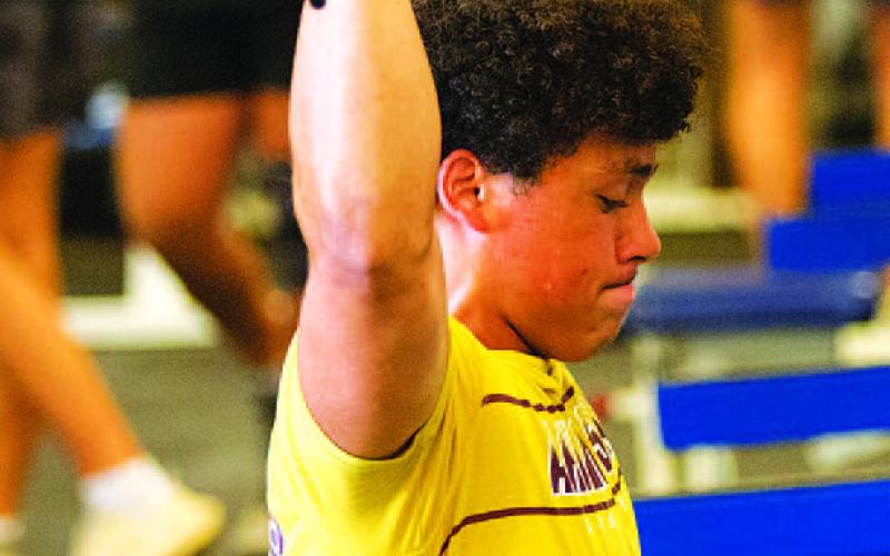 HUNTER KING | DISPATCH RECORD KJ Reed lifts weights with his fellow athletes.