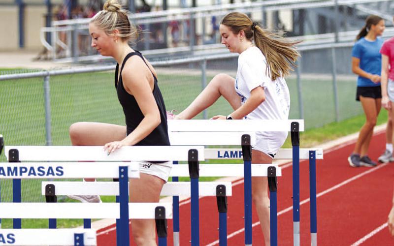 Brailey Wilson, left, and Abbey Green move through the hurdles last week during SWAT. HUNTER KING | DISPATCH RECORD