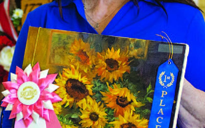 HUNTER KING | DISPATCH RECORD Pamela Ekizian won the overall reserve grand champion with her sunflower oil painting.