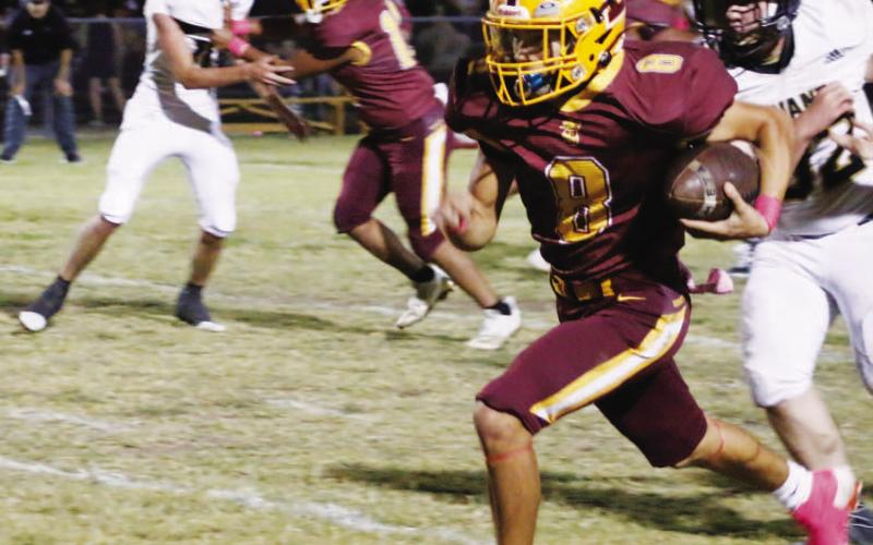 MASON HINES | DISPATCH RECORD Senior Brandon Moore looks for room to accelerate during one of his two touchdown runs in Friday’s 60-14 win over Evant.