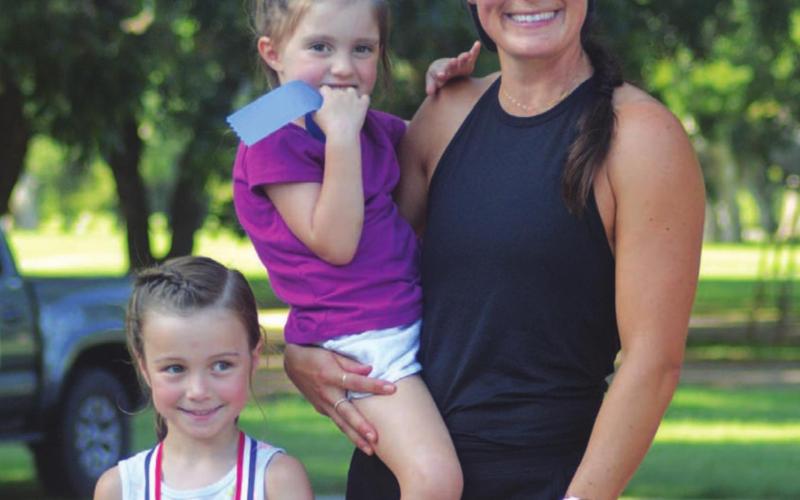 Drea Gibson poses with her children after she was the first female to finish the 10K Saturday. CHARLES WILSON | COURTESY PHOTO
