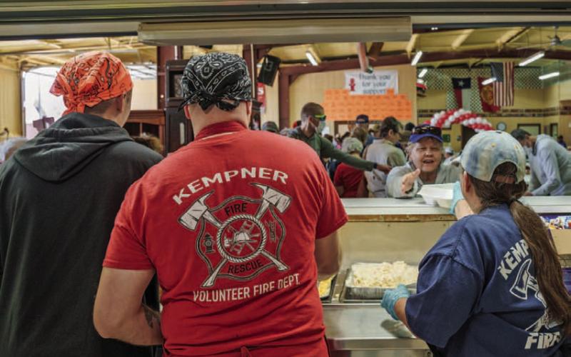 Kempner VFD volunteers Collin Martin, Steven Martin and Norine Martin are pictured left to right serving guests at the Kempner VFD BBQ and Auction in the spring of 2023. FILE PHOTO