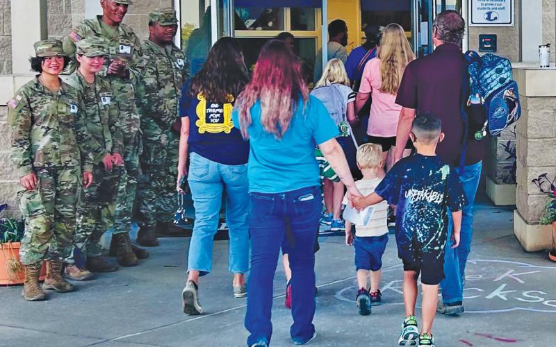 Soldiers from the 720th Military Police Battalion and 89th MP Brigade greeted Taylor Creek Elementary School students, parents and faculty for the first day of school on Friday. courtesy photo