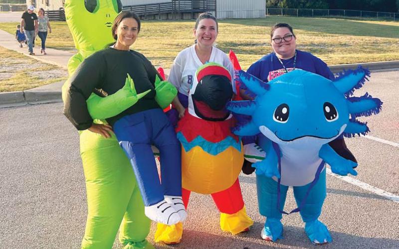 Taylor Creek Elementary School staff members, from left, Lori Gardner, Stephanie Skogland and Aleia Wardlow brought fun to the first day of school with some inflatable costumes. courtesy photo