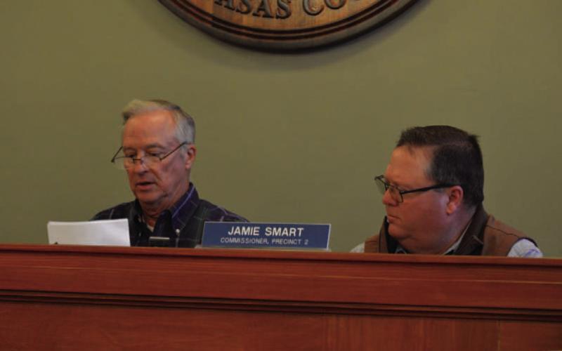 At left, County Judge Randy Hoyer unseals proposed bids for courthouse renovations as Precinct 2 Commissioner Jamie Smart looks on. ERICK MITCHELL | DISPATCH RECORD