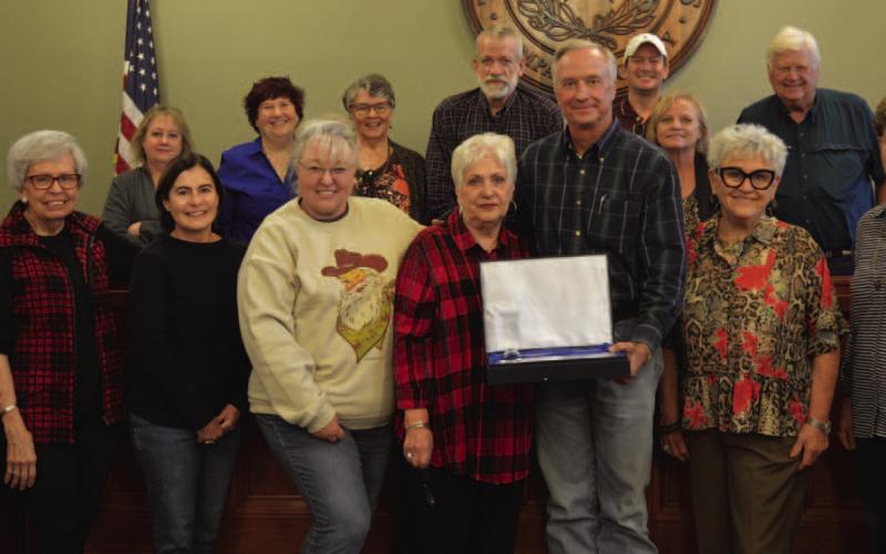 County Judge Randy Hoyer presents a gift to outgoing Lampasas County Historical Commission Chairman Clydell Wallace, in center, surrounded by other members of the commission. ERICK MITCHELL | DISPATCH RECORD