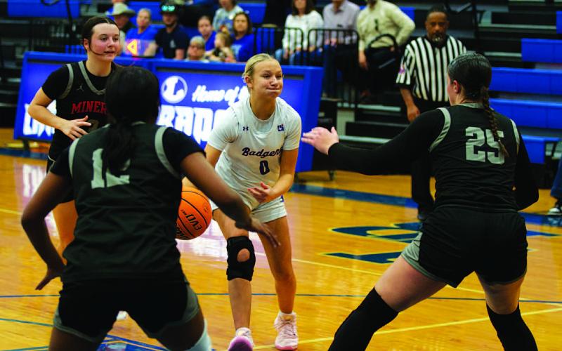 HUNTER KING | DISPATCH RECORD Tenley Langford tries to make a pass between two Lady Rams.