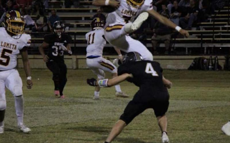 Alonso Caso hurdles over an Evant defender during the Hornets’ dominant win last week. JESSICA MALDONADO | DISPATCH RECORD