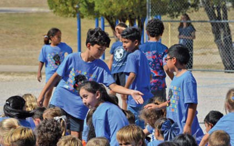 Erick Mitchell | Dispatch Record Wyatt Ball, a member of the World Changers group, gives one of his classmates a low five for his success during the first nine weeks.