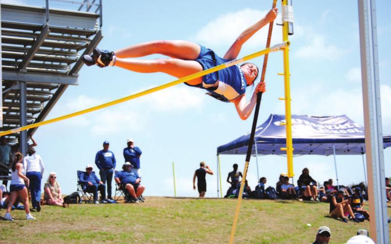 Peyton Tatum vaults over the bar in her first round and on her way to a fourth-place finish at the district meet. HUNTER KING | DISPATCH RECORD