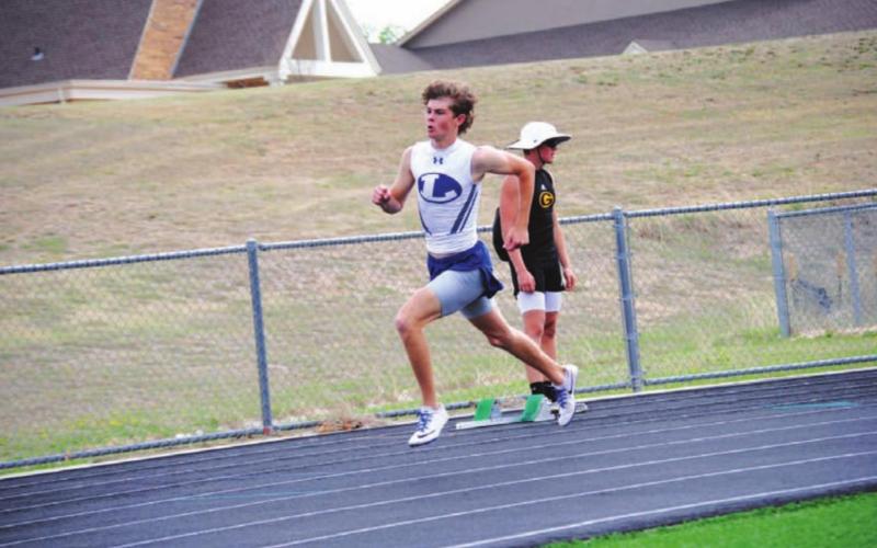 Nate Borchardt rounds the first curve during his 400-meter race where he finished second. HUNTER KING | DISPATCH RECORD