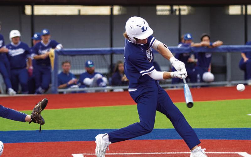 Timber Gholson swings at a pitch during the early innings against the Cougars. HUNTER KING | DISPATCH RECORD