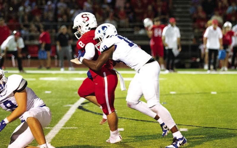 Trenton Hobbs wraps up the Salado quarterback as he tries to scramble away. HUNTER KING | DISPATCH RECORD