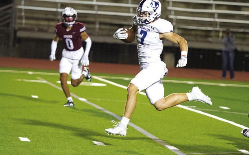 Jett Walker breaks up the middle to score one of his two touchdowns last week. HUNTER KING | DISPATCH RECORD