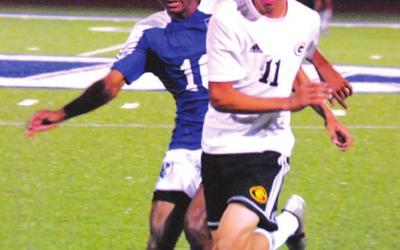 KJ Stephens chases down the ball against a Gatesville player in his final home game of Badger soccer. HUNTER KING | DISPATCH RECORD