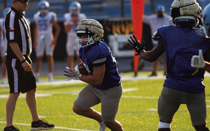 KJ Reed runs in the open field during the second scrimmage of the season last Thursday. HUNTER KING | DISPATCH RECORD
