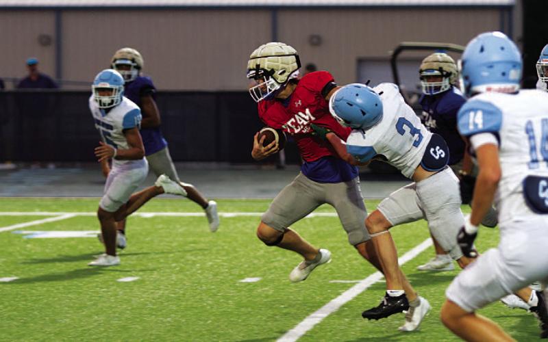 Bryson Roberts fights off a China Spring defender on a scramble. HUNTER KING | DISPATCH RECORD