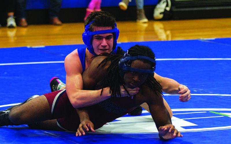Gabriel Woodfin holds down his opponent at Wednesday’s home wrestling meet. HUNTER KING | DISPATCH RECORD