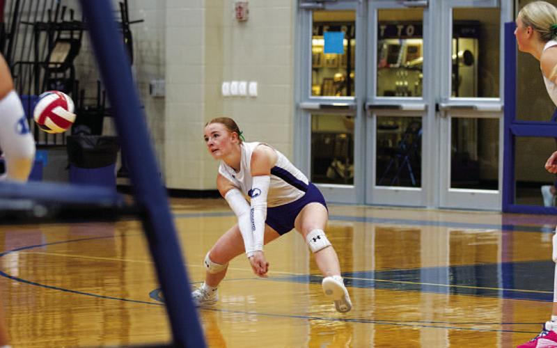 HUNTER KING | DISPATCH RECORD Caitlyn Bengsch drops down to play a pass to a teammate. The sophomore has been growing in her first varsity season.