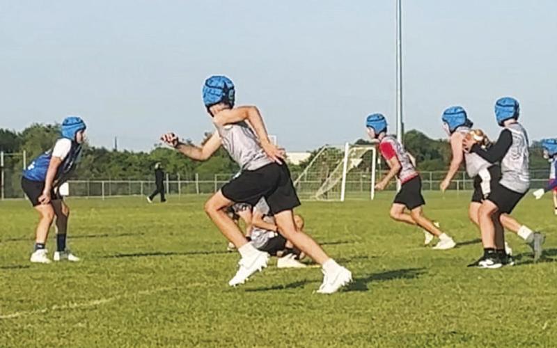 As the ball is snapped, receivers take off on their routes. COURTESY PHOTO