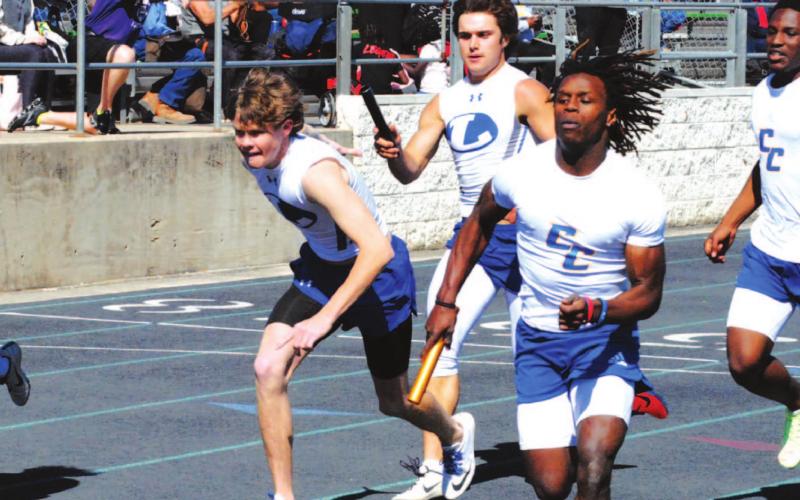 Aden Rascoe passes the baton to Nate Borchardt during the Badgers’ 4x200 meter relay race last Thursday. HUNTER KING | DISPATCH RECORD